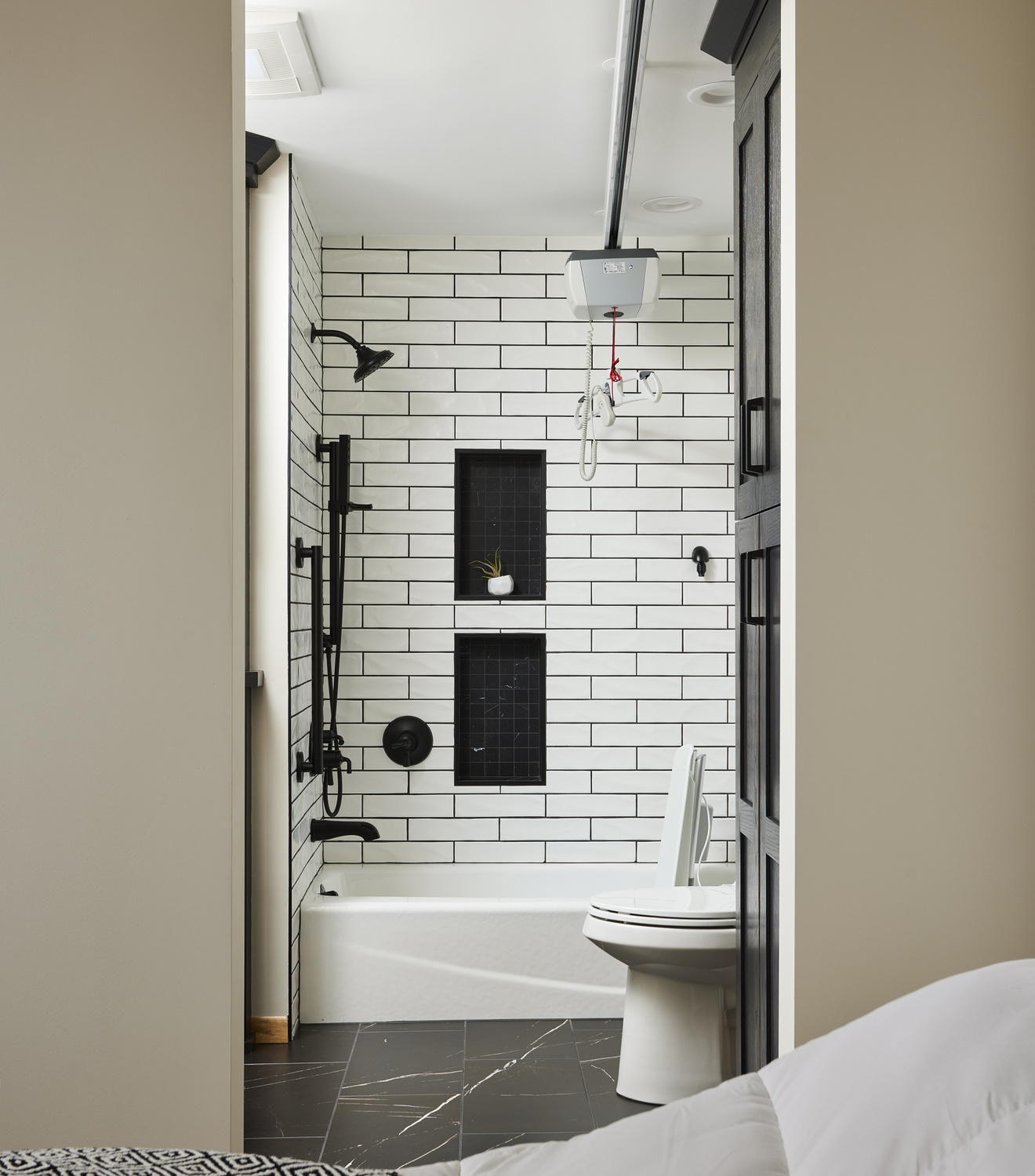 Assisted lift between the primary bedroom and bathroom.
